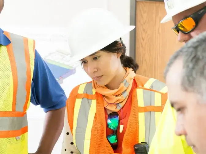 Female Keller project manager talking with colleagues