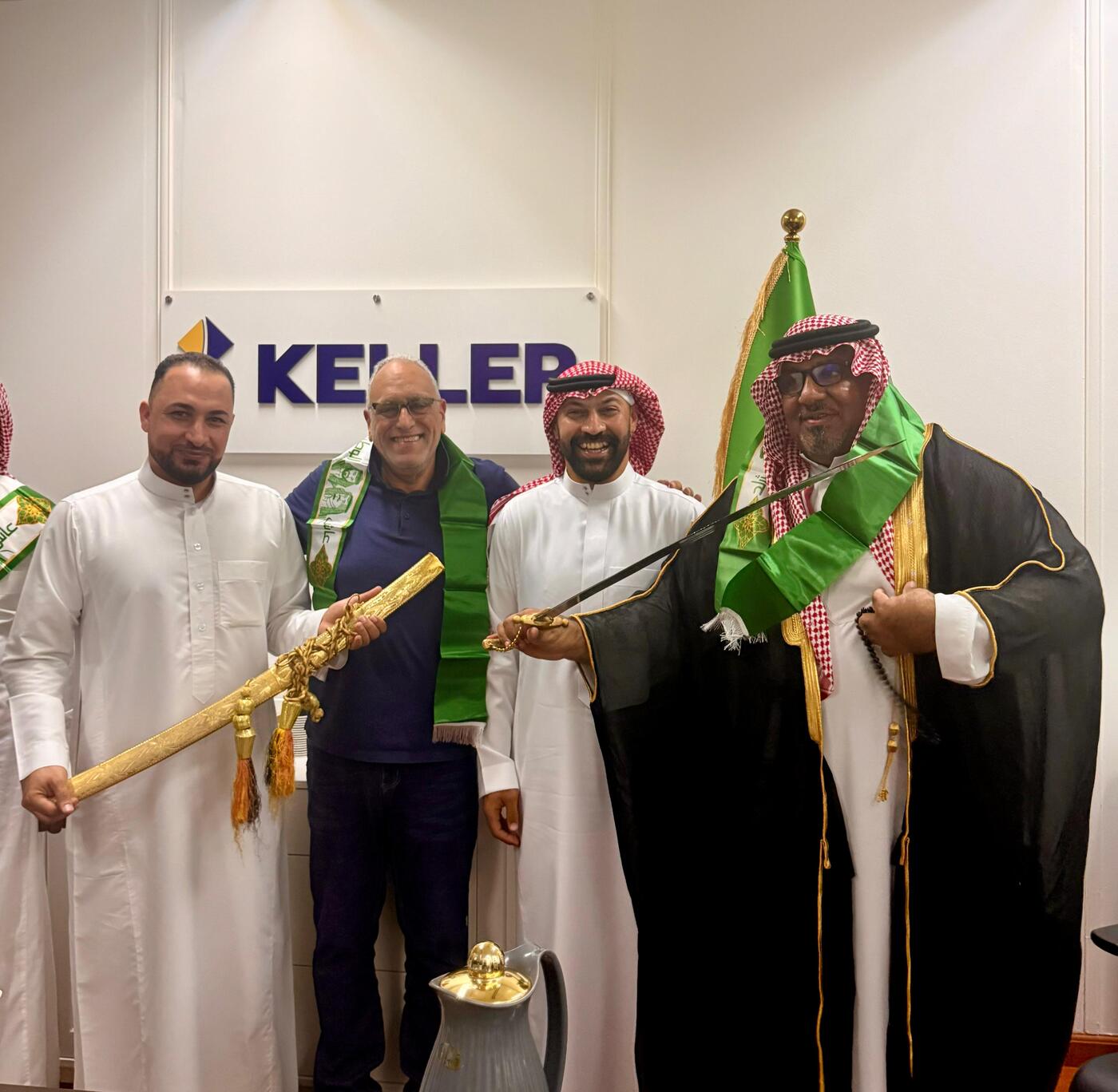 Keller colleagues holding ornamental sword during Saudi Arabia's national day ceremony