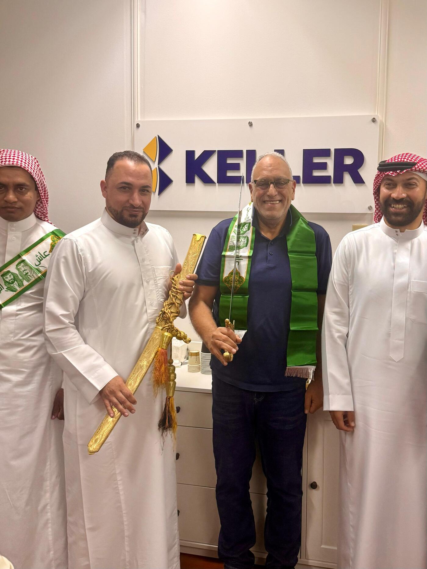 Employees holding ornamental sword while celebration Saudi Arabia's National Day