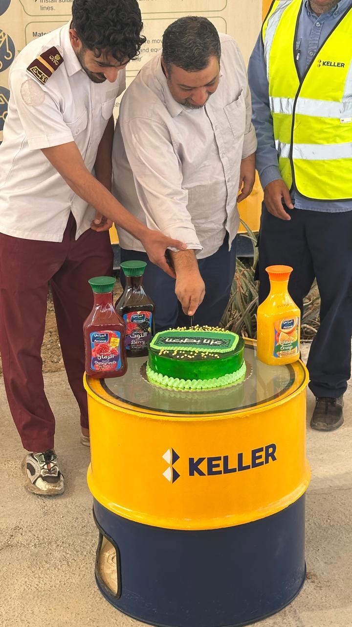 Employees cutting the cake