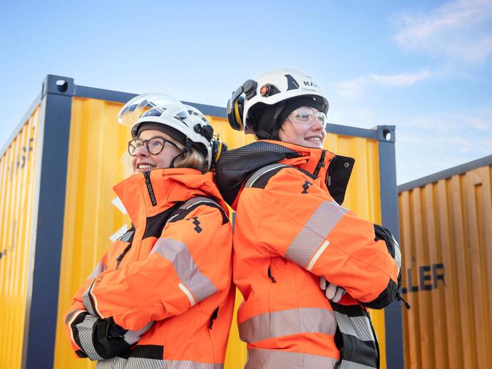 Two female Keller employees standing back to back